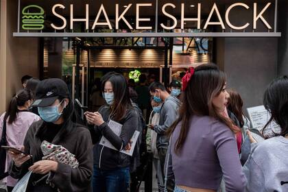 La gente hace cola frente a un restaurante Shake Shack afuera de un centro comercial durante el feriado nacional de la "Semana Dorada" en Pekín el 2 de octubre de 2020.