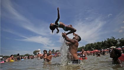 La gente juega en el estanque artificial conocido como piscinao, o piscina grande, al norte de Río de Janeiro en Brasil.