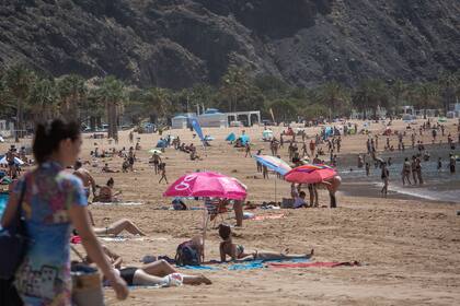 La gente toma el sol en la playa de Las Teresitas en la isla española de Tenerife Canry el 25 de mayo de 2020, el primer día después de que las playas reabrieron en algunas partes del país tras meses de encierro por el coronavirus