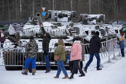 La gente visita una exhibición de tanques y APC de las fuerzas armadas ucranianas dañados y capturados durante los combates en una exhibición en Kirovsk, a unos 30 kilómetros (19 millas) al este de San Petersburgo, Rusia, el 22 de enero de 2023. (Foto AP/Dmitri Lovetsky)