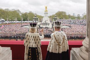 La multitud reunida frente a Buckingham recibe el saludo de Carlos III y Camilla.
