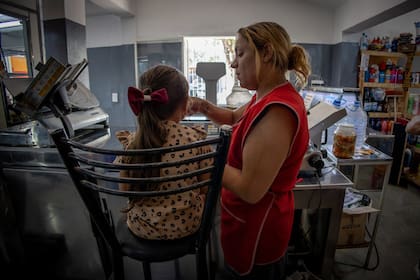 La niña, con su madre en el almacén donde ella trabaja