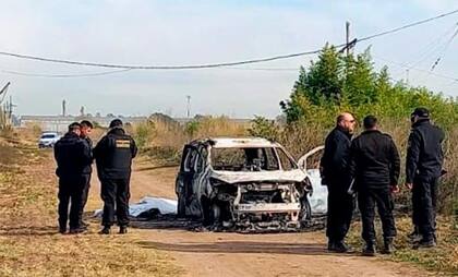 La policía, en el lugar del hallazgo del cadáver de Georgina Maricruz Olguín, de 24 años, junto al auto carbonizado en las afueras de Rosario