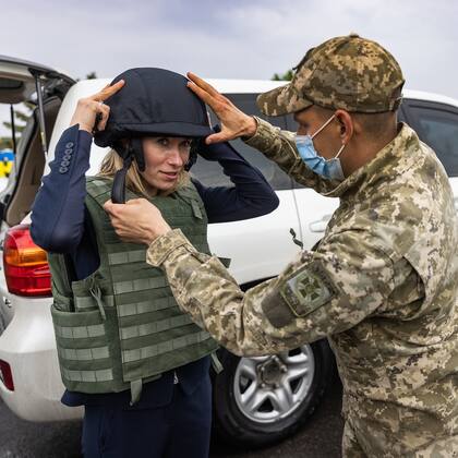 La primera ministra de Estonia, Kaja Kallas, ayudada por un militar