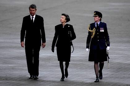 La Princesa Real y el vicealmirante Timothy Laurence son recibidos por el Capitán del Grupo de Comandantes de la Estación McPhaden después de haber desembarcado del C-17 que lleva el ataúd de la Reina Isabel II en la Royal Air Force Northolt, al oeste de Londres