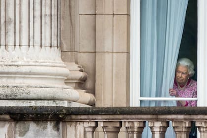 La Reina Isabel II mira por la ventana del Palacio de Buckingham antes de asistir al Almuerzo Patronal en honor al 90 cumpleaños de la Reina, 12 de junio de 2016