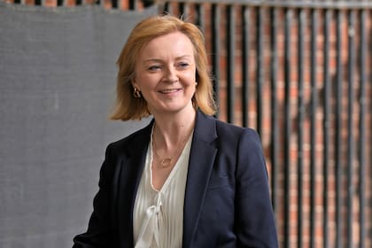 FILE - Elizabeth Truss Britain's Secretary of State for Foreign, Commonwealth and Development Affairs speaks to an aide as she leaves Downing Street in London, May 18, 2022. The contest to succeed British Prime Minister Boris Johnson has no single frontrunner but there are many prominent contenders. Truss, 46, took on the high-profile Cabinet post in September after serving as trade minister. She has been gaining momentum as a contender since then and has made no secret of her ambitions. (AP Photo/Alastair Grant, File)