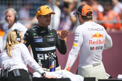 Lando Norris y Max Verstappen dialogan en el circuito de Spielberg, tras la carrera Sprint que ganó el neerlandés el sábado; un día después, la batalla en la pista superó los límites terminó con un accidente