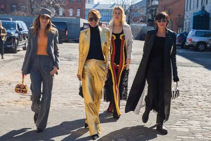 Las argentinas Verónica Lozano, Titi Vázquez y Paola Pravato, seguidas por la productora Lilly Hartley (con vestido con detalles amarillos y rojos) llegan al Agger Fish Building, en Brooklyn, lookeadas por Hearst.
