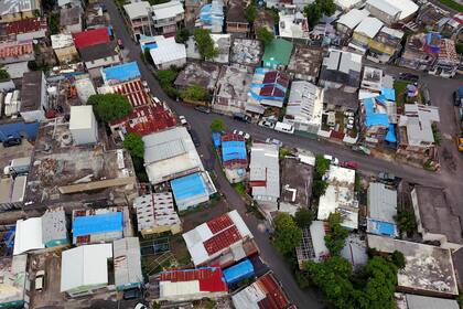 Las lonas azules que se usaron para proteger los techos dañados por el huracán María, en San Juan de Puerto Rico, están dañadas y las casas tienen filtraciones cuando llueve