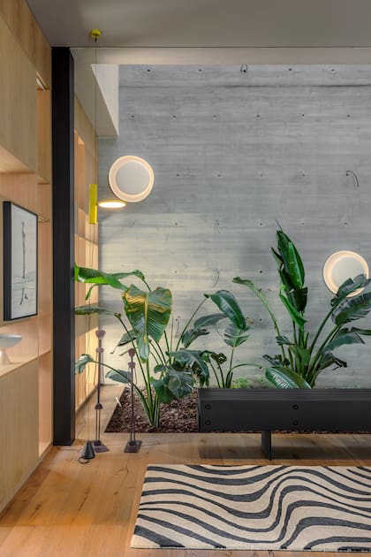 Las ondas de la alfombra de Vanina Mizrahi acompañan increíblemente bien el patio interno de espíritu tropical proyectado por la arquitecta Gabriela Barrionuevo.