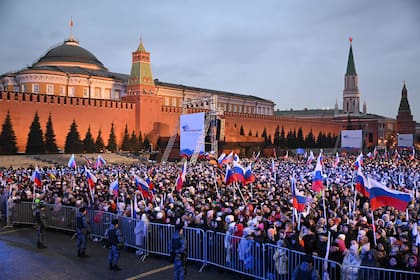 Las personas asisten a un evento por el décimo aniversario de la anexión de Crimea por parte de Rusia, en la Plaza Roja de Moscú el 18 de marzo de 2024. 