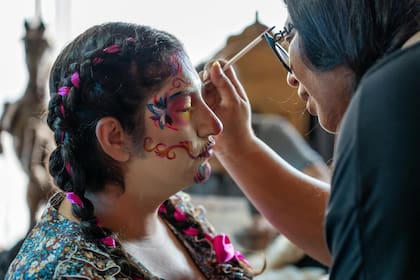 Las personas se pintan como calacas coloridas para venerar a sus seres queridos fallecidos