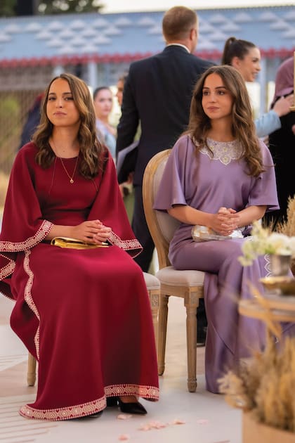 Las princesas Salma e Iman también deslumbraron con sus looks. Salma llevó un vestido con mangas XL con ribetes bordados en hilo dorado mientras que su hermana mayor optó por un modelo similar satinado en tono malva con mangas acampanadas y aplicaciones de encaje blanco.