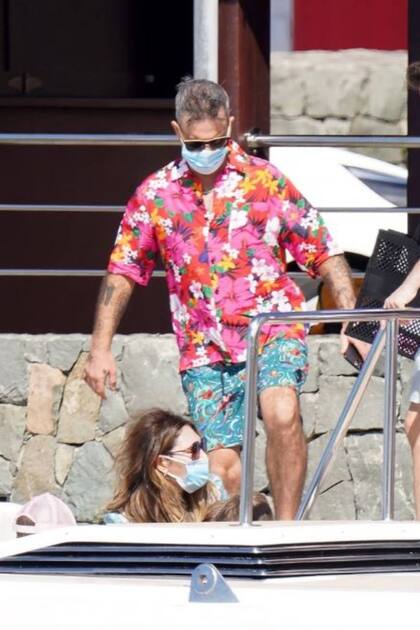 Las últimas fotos tomadas a Robbie Williams y a su esposa Ayda Field en St. Barth demostraron que el cantante se cuidaba del virus con un tapabocas, aunque no le alcanzó