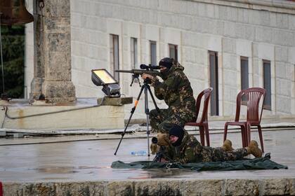 Lebanese security personnel deploy on the roof of the Monastery of Saint Maroun ahead of Pope Leo XIV's arrival in Annaya, Lebanon, Monday, Dec. 1, 2025. (AP Photo/Hassan Ammar)
