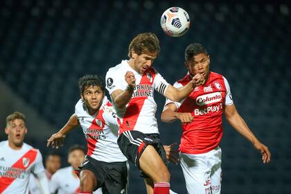 Leonardo Ponzio, que volvió al equipo, despeja con la cabeza luego de un ataque de Independiente Santa Fe. 