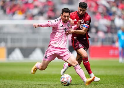 Lionel Messi busca escapar de la marca de Jonathan Osorio, en la visita de Inter Miami a Toronto por la MLS