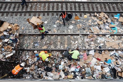 LOS ANGELES, CALIFORNIA - Los trabajadores deben limpiar para despejar las vías de los trenes de carga de Union Pacific. Mario Tama/Getty Images/AFP
