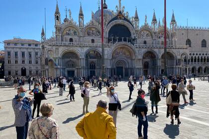 Los comerciantes que solicitan la reapertura de las tiendas y las actividades comerciales se reúnen para una protesta flashmob en la Piazza San Marco el 4 de mayo de 2020 en Venecia, mientras Italia comienza a aliviar su bloqueo