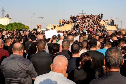 Los dolientes asisten al funeral de las víctimas que murieron cuando un incendio arrasó un salón de bodas abarrotado en la ciudad septentrional de Qaraqosh, también conocida como Hamdaniyah, de mayoría cristiana, el 27 de septiembre de 2023. (Foto de Zaid AL-OBEIDI / AFP)