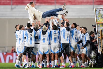 Los futbolistas de la Argentina levantan a Di María en el homenaje por su retiro del seleccionado en la previa de un partido contra Chile, en el Monumental