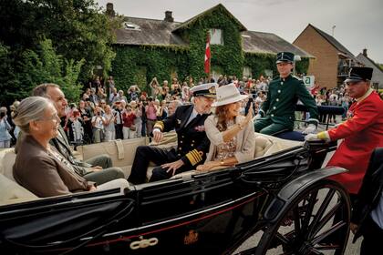 Los habitantes de Samsø saludan a los Reyes durante el paseo que hicieron en un carruaje antiguo por las calles de la isla, junto al alcalde Marcel Meijer y su mujer, Kirsten OEstergaard Meijer, el 28 de agosto pasado