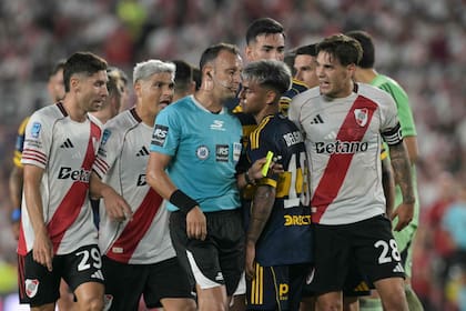 Los jugadores de River enfurecidos rodean al árbitro