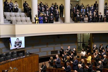 Los legisladores aplauden tras el discurso por videoconferencia del presidente ucraniano Volodymyr Zelensky en el Parlamento finlandés en Helsinki, Finlandia, el 8 de abril de 2022.