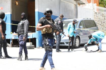 Los miembros de la policía y los forenses de Haití buscan evidencia fuera de la residencia presidencial en Puerto Príncipe, Haití