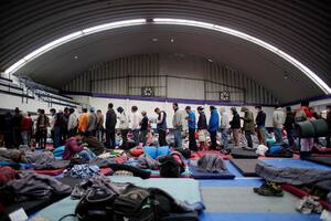 Los migrantes hacen fila para recibir comida en un refugio provisional durante su viaje hacia los Estados Unidos, en Puebla, México, el 28 de enero.