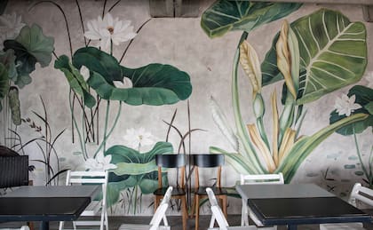 Los murales son una buena solución para dar calidez y color a los ambientes. En este caso se eligieron lotos y hojas de gran escala que agrandan visualmente el espacio y generan profundidad