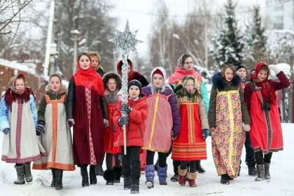Los niños y los adultos salen a la calle para juntarse el día de Navidad en las ciudades donde predomina la religión Ortodoxa