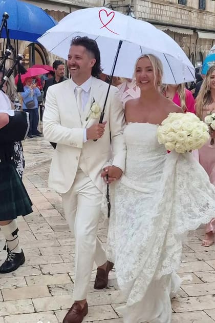 Los novios y los invitados tuvieron que usar paraguas para protegerse de la lluvia antes y después de dar el "sí, quiero" en el altar.