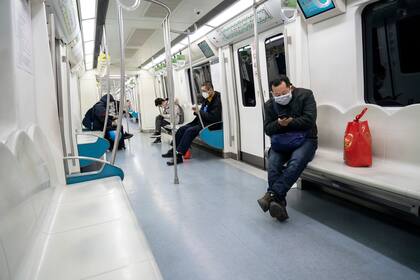 Los pasajeros viajan en un subte casi vacío en Pekín el 3 de febrero de 2020