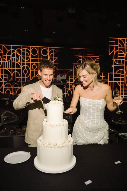 Los recién casados cortan la torta, que fue hecha por Damián Betular