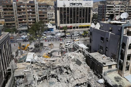 Los trabajadores de rescate buscan entre los escombros de un edificio anexo a la embajada iraní un día después de un ataque aéreo en Damasco el 2 de abril de 2024.
