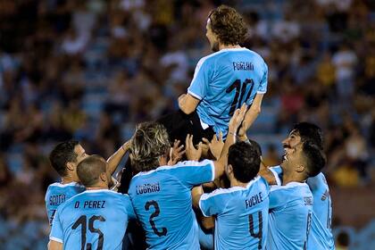Los uruguayos alzan a Forlán durante el amistoso