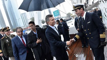 Macri saluda a cadetes egresados de la Escuela Naval. Atrás, el ministro de Defensa, Julio Martínez