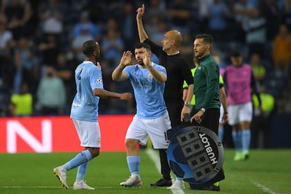 Manchester City's English forward Raheem Sterling (L) is greeted as he leaves the pitch by Manchester City's Argentine forward Sergio Aguero during the UEFA Champions League final football match between Manchester City and Chelsea FC at the Dragao stadium in Porto on May 29, 2021. (Photo by David Ramos / POOL / AFP)