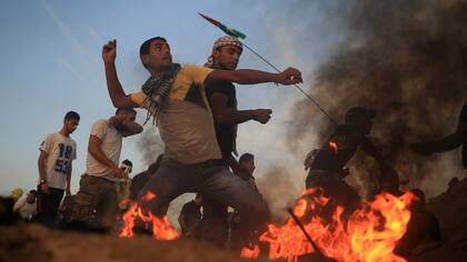 Manifestantes palestinos lanzan piedras a las fuerzas israelíes en Gaza