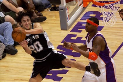Manu Ginóbili intenta evitar que la pelota se salga del campo bajo presión de Quentin Richardson de los Phoenix Suns en el Juego una de las finales de la Conferencia Oeste durante los NBA Playoffs del 22 de mayo de 2005 en el America West Arena en Phoenix, Arizona. Los Spurs ganaron 121-114