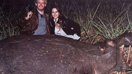 Matías Garfunkel y Victoria Vannucci posan junto a un hipopótamo muerto.
