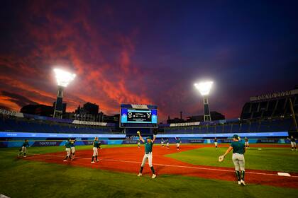 Members of team Australia warm up before a a softball game against Mexico at the 2020 Summer Olympics, Monday, July 26, 2021, in Yokohama, Japan. (AP Photo/Matt Slocum)