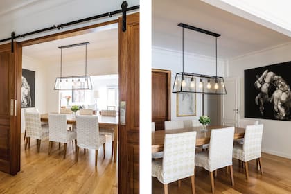 Mesa de petiribí bajo una lámpara diseñada por el Estudio AT Arqs. Fundas (Didot Estudio). Dos obras de Julio Lavallén: Ouroboros, acrílico sobre lienzo y, junto a la puerta, La Salida, técnica mixta sobre madera.