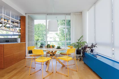 Mesa (La Feliz) con sillas amarillas (Números Primos). La lámpara existente se incluyó en el proyecto. Cortinas de lino 'Indigo 300' (De Levie) hechas a medida por Gabriela Pérez Elizalde.