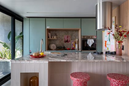 Mesada y alzada en mármol Silver Galaxy con terminación apomazada. Isla de mármol Fior di Pesco pulido. Desarrolladas por marmolería Baccarelli para el espacio de Sara Plazibat.