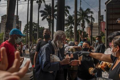 Miembros de la iglesia evangélica Frutos do Senhor ofrecen el desayuno a indigentes sin techo en el centro de San Pablo