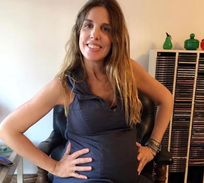 Mostrando, orgullosa, su panza de embarazada.