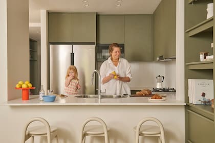 Mueble de cocina en melamina ‘Safari’ (Faplac), diseñado a medida por el Estudio. Mesadas blancas de Silestone.